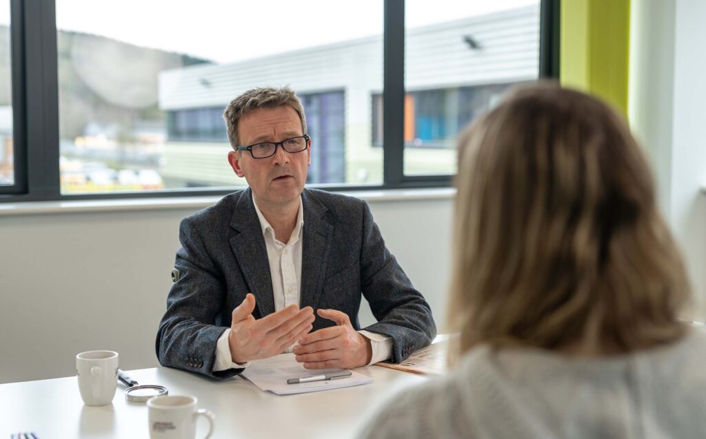 Steve Heathcote speaking with a client during a financial planning meeting