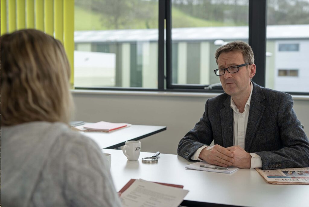 Steve Heathcote, Chartered Financial Planner, meeting a client