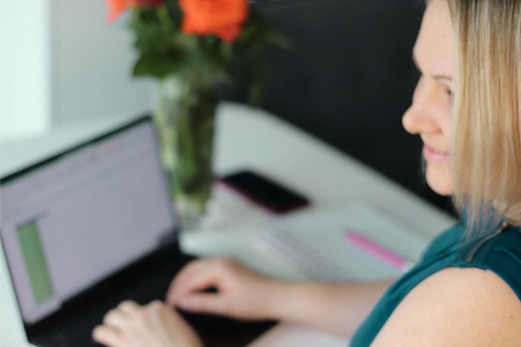 Vera Jezkova, Marketing Director, working on a laptop