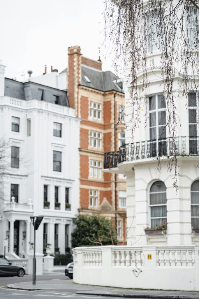 Elegant townhouses on a city street with balconies and bare tree branches